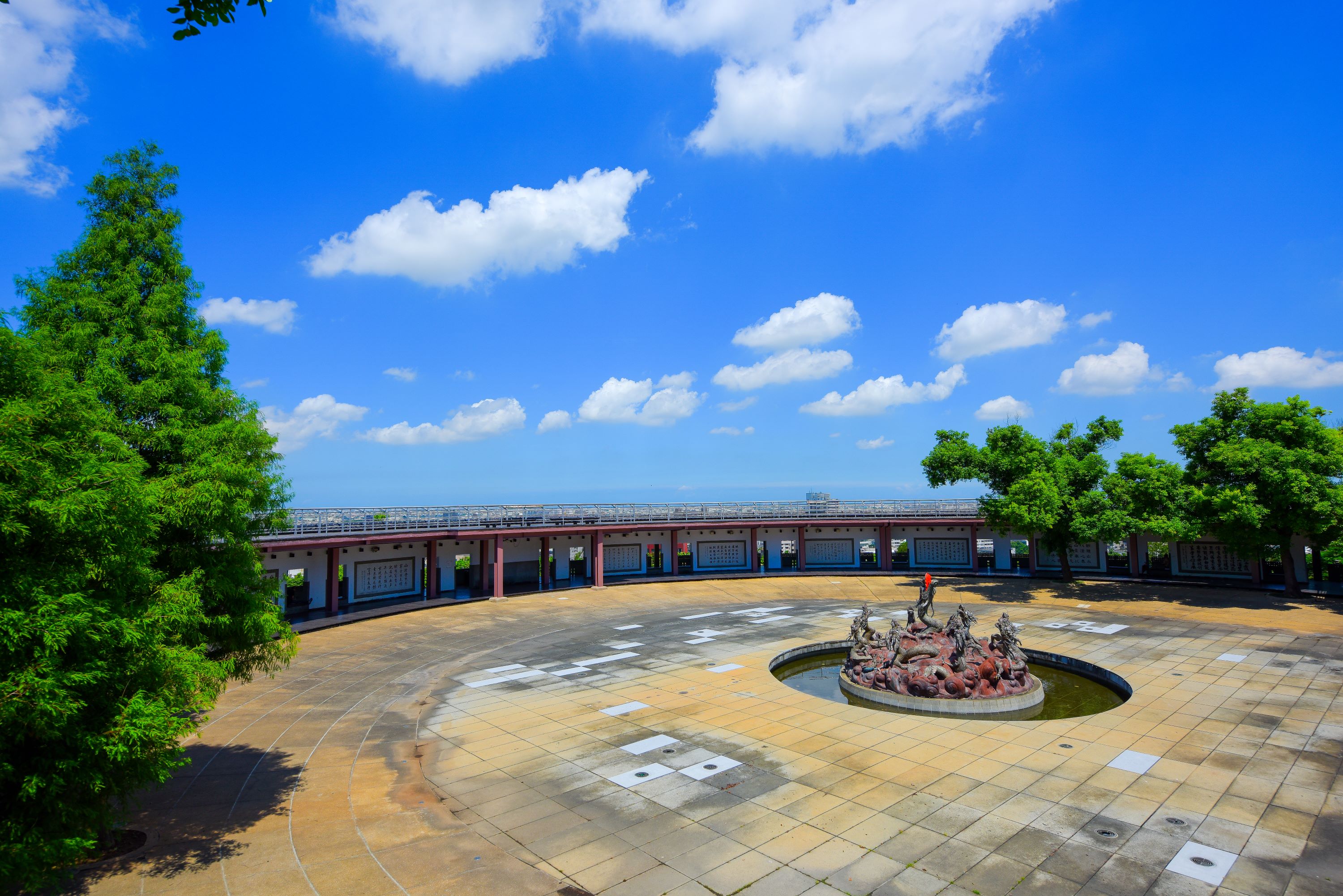 Nine Dragon Plaza located in front of the Great Buddha statue, near the end of the Buddha Steps. The periphery of the plaza is a suspended walkway that offers 270-degree landscape viewing. The design 